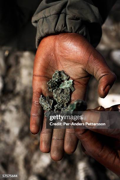 Unidentified mine workers holds copper in their hands on December 13, 2005 in Ruashi mine about 20 kilometers outside Lubumbashi, Congo, DRC. About...