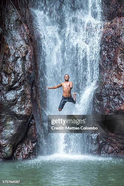local man jumping off a waterfall, kadavu, fiji - fiji people stock pictures, royalty-free photos & images