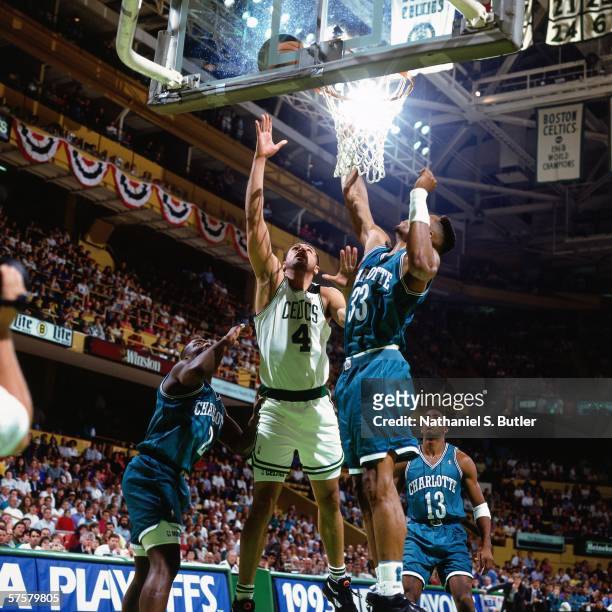 Alaa Abdelnaby of the Boston Celtics shoots a layup against Alonzo Mourning of the Charlotte Hornets during game one of the Eastern Conference...