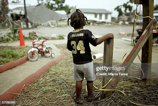 Shanika Reaux's son Da-Vone Lewis stands in the front yard of their residence in the Lower Ninth Ward May 10, 2006 in New Orleans, Louisiana. Reaux's...