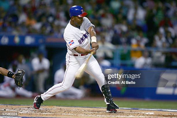 Moises Alou of the Dominican Republic bats against Puerto Rico during the second round of the World Baseball Classic at Hiram Bithorn Stadium on...