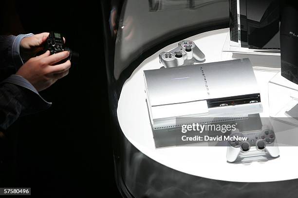 Show attendee photographs the latest PlayStation 3 devices on day one of the Entertainment Software Association's 2006 Electronic Entertainment Expo...