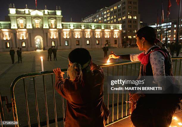 Una mapuche y su hijo prenden velas mientras participan de un acto para reclamarle al gobierno la libertad de 4 dirigentes de sus dirigentes...