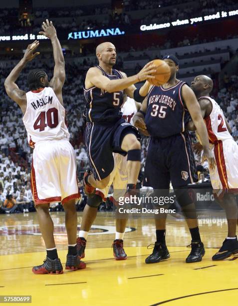 Jason Kidd of the New Jersey Nets drives past Udonis Haslem of the Miami Heat to complete a pass in the first quarter of game two of the Eastern...
