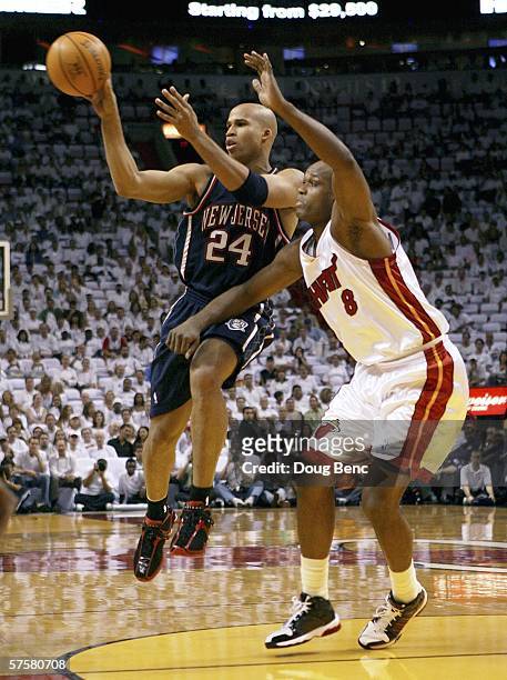 Richard Jefferson of the New Jersey Nets passes the ball against Antoine Walker of the Miami Heat in game two of the Eastern Conference Semifinals...