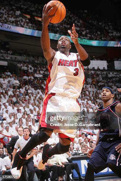 Dwyane Wade of the Miami Heat shoots against Vince Carter of the New Jersey Nets in game two of the Eastern Conference Semifinals during the 2006 NBA...