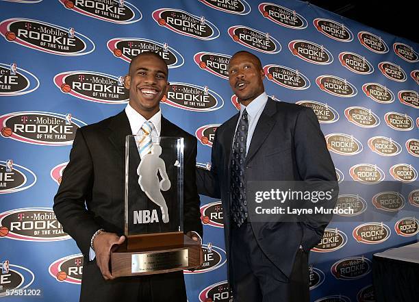 Chris Paul of the New Orleans/Oklahoma City Hornets holds the Eddie Gottlieb Trophy, alongside head coach Byron Scott, after being named the 2006 NBA...