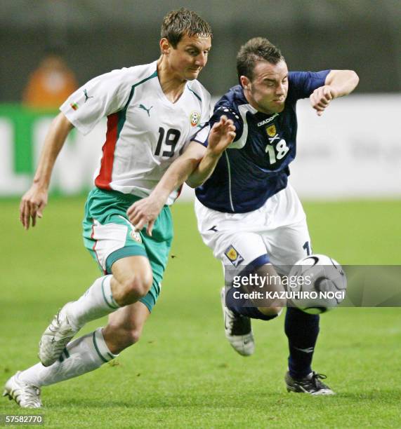 Scotland's forward Kris Boyd and Bulgarian defender Asen Karaslavov fight for the ball in the first half of the Kirin Cup football match against...