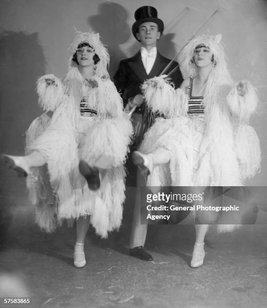 American vaudeville performers Rosy and Jenny Dolly, known professionally as The Dolly Sisters, simulate a carriage team of white horses in their...