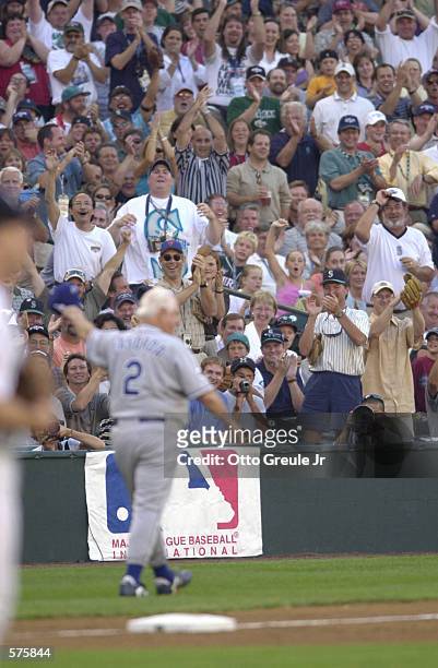 The crowd cheers former Los Angeles Dodgers manager Tommy Lasorda after Lasorda was struck by a flying bat while coaching third base during the 2001...