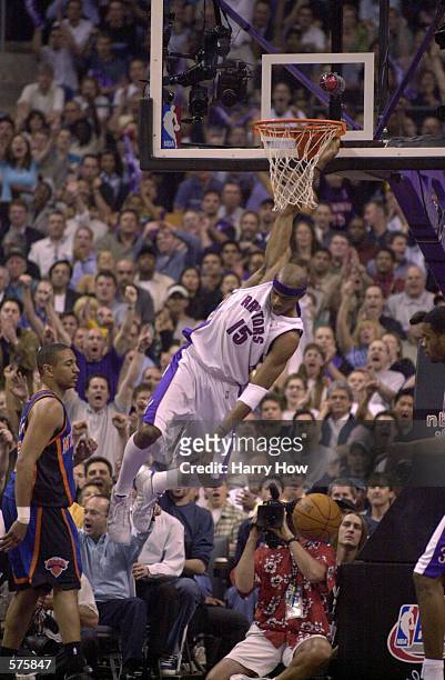 Vince Carter of the Toronto Raptors slam-dunks in game four of round one of the NBA playoffs against the New York Knicks at the Air Canada Centre in...