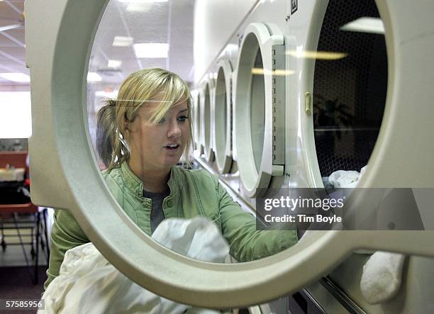 Katie Reynolds pulls out clothing from a Maytag commercial dryer at a Maytag laundromat May 11, 2006 in Mount Prospect, Illinois. Whirlpool...