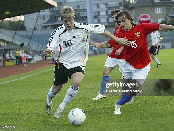 Toni Kroos of Germany vies for the ball with Roman Amirhanov of Russia during the UEFA Under 17 European Championship semi final match between...
