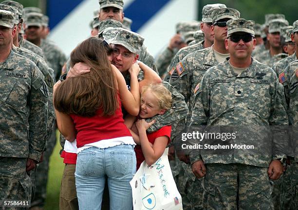 Georgia National Guardsman Lt. Col. George Fisher of Macon, Georgia hugs his daughter Amanda , son Joe and youngest daughter, Lyndsay , prior to...