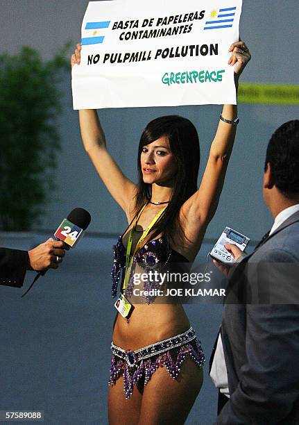 Greenpeace demonstrator Argentine Evangelina Carrozo, shows a banner to media against pulp mills plants installation in Fray Bentos, Uruguay over the...