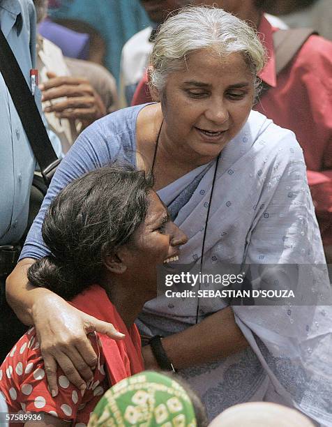 Activist Medha Patkar comforts a woman at a protest rally held against the government for demolishing their hutments at Mandala in Mankhurd in north...