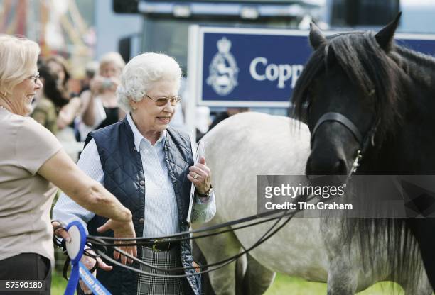 Queen Elizabeth II inspects fell ponies and chats to their owners on the second day of the Royal Windsor Horse Show on May 12, 2006 in Windsor,...