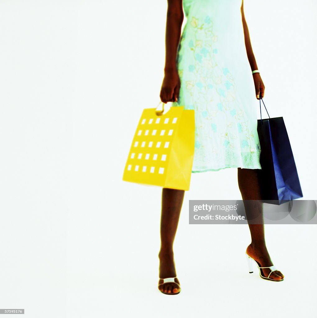 Woman standing holding shopping bags