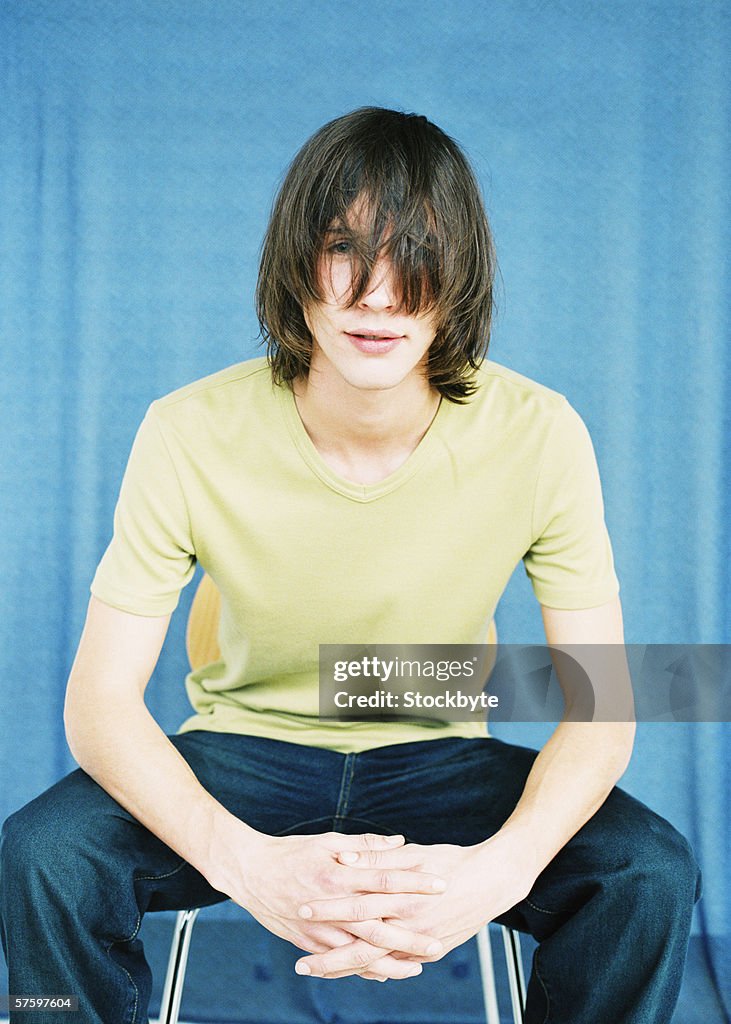 Front view portrait of a young man with his hair on his face