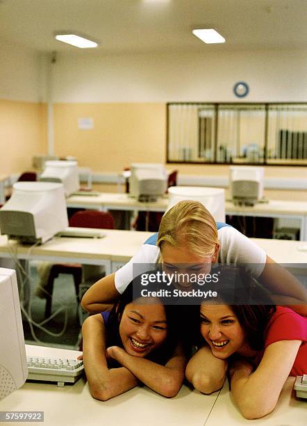 three young women together in a class room - bent elbow stock pictures, royalty-free photos & images