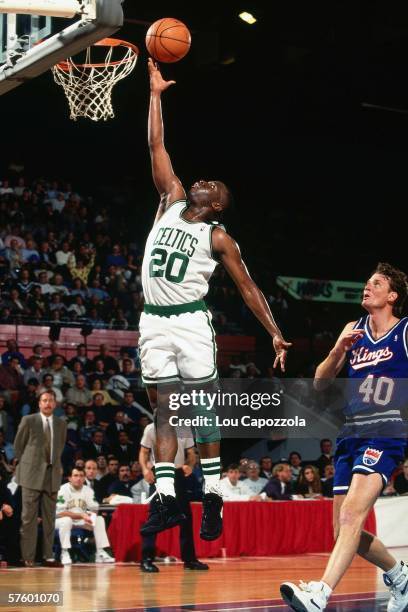 Sherman Douglas of the Boston Celtics drives in for a layup against the Sacramento Kings during a game at the Boston Garden on October 26, 1993 in...