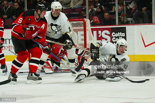 Center Sidney Crosby of the Pittsburgh Penguins falls near defenseman Colin White of the New Jersey Devils on March 16, 2006 at the Continental...