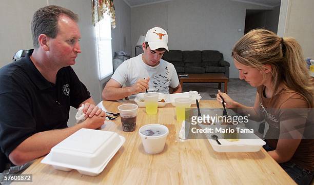Cabrini High School junior Danielle DiMaggio eats a box dinner with boyfriend Ben Navo and her father David in the temporary trailer where she...