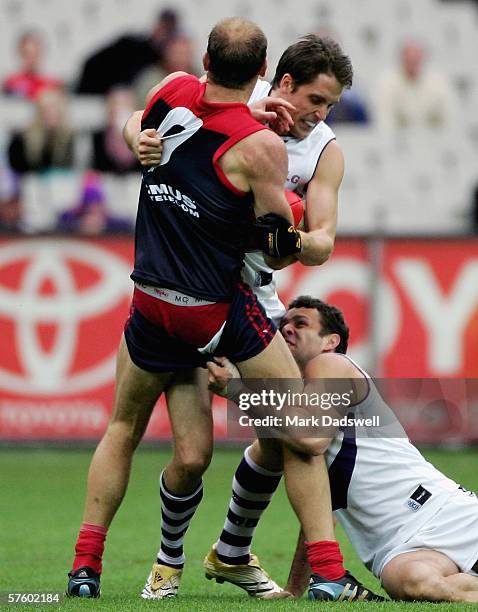 David Neitz of the Demons loses his shorts in a tackle by Luke McPharlin and Antoni Grover of the Dockers during the round seven AFL match between...