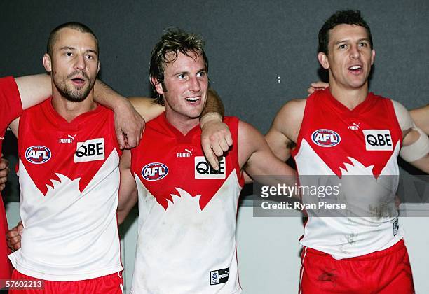 Nick Malceski, Jude Bolton and Leo Barry of the Swans sing the club song after the round seven AFL match between the Richmond Tigers and the Sydney...