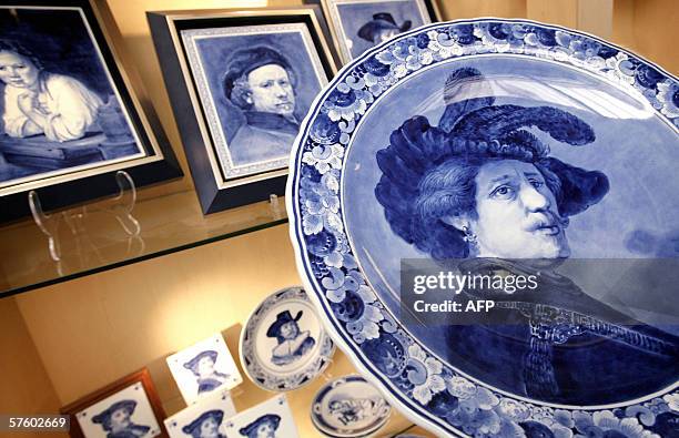 Netherlands-tourism-art-Lifestyle" Tiles and plates with Rembrandt reproductions in delft blue style on display at a shop in the Koninklijke...