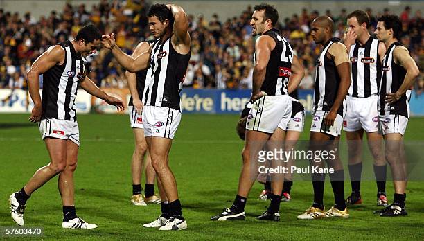 Magpies players look dejected after losing the round seven AFL match between the West Coast Eagles and the Collingwood Magpies at Subiaco Oval May...