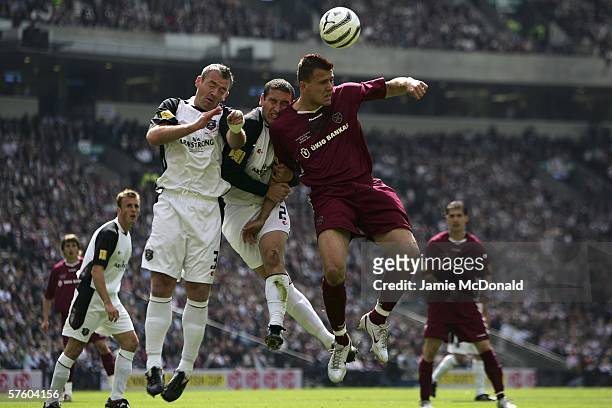 Roman Bednar of Hearts jumps with Mark Birch and David Nichols of Gretna during the Tennents Scottish Cup Final between Heart of Midlothian and...