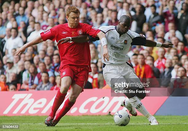 John Arne Riise of Liverpool and Marlon Harewood of West Ham United and challenge for the ball during the FA Cup Final match between Liverpool and...