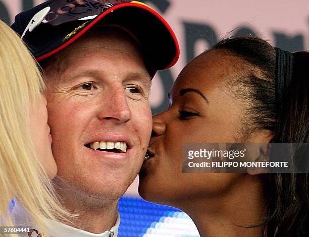 Belgium's Rik Verbrugghe of team Cofidis is kissed by the misses on the podium as he celebrates his victory after the seventh stage of the Giro...