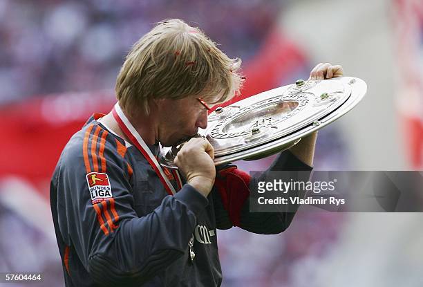 Oliver Kahn of Bayern kisses the trophy for the German Champion after the Bundesliga match between FC Bayern Munich and Borussia Dortmund at the...