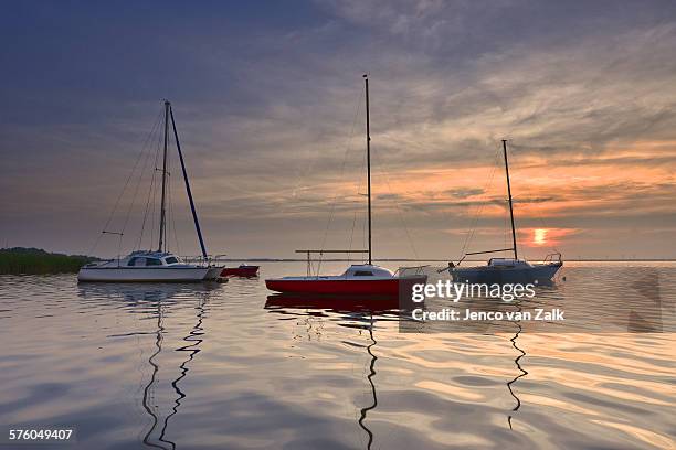 little ships at sunset - jenco van zalk stock pictures, royalty-free photos & images