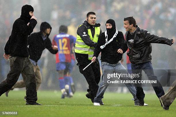 Steward tries to prevent FC Basel suppporters invading the pitch after FC Zurich won 2 to 1 over FC Basel and is Swiss football champion during the...