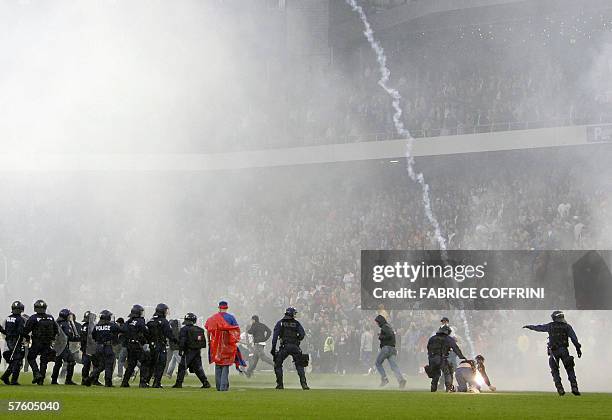 Riot police try to prevent FC Basel suppporters invading the pitchafter FC Zurich won 2 to 1 over FC Basel and is Swiss football champion during the...