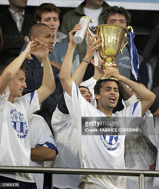 Zurich's Alexandre Alphonse raises with teammates the trophy of Swiss football champion after his team won 2 to 1 over FC Basel, during the last day...