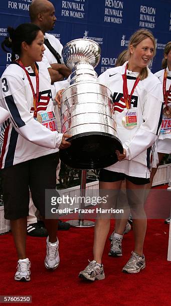 Members of the 2006 Olympic Women's Ice Hockey Team Julie Chu, and Helen Resor, carry the NHL Stanley Cup at the 13th Annual Revlon Run/Walk For...