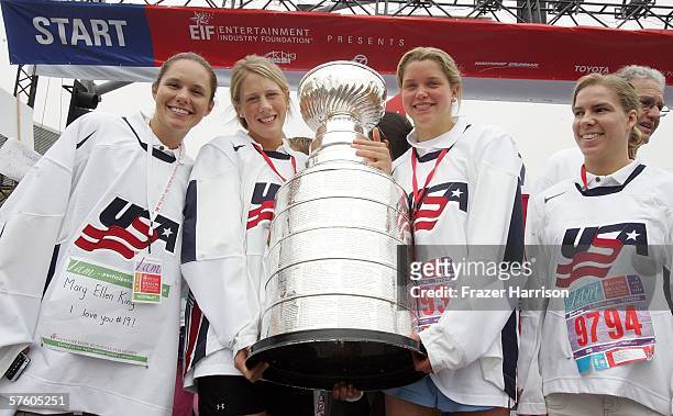 Members of the 2006 Olympic Women's Ice Hockey Team Chanda Gunn, Helen Resor, Sarah Parsons, and Jenny Potter, carry the NHL Stanley Cup at the 13th...