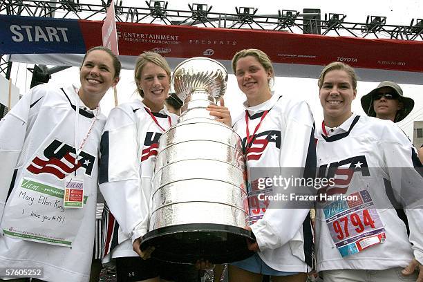 Members of the 2006 Olympic Women's Ice Hockey Team Chanda Gunn, Helen Resor, Sarah Parsons, and Jenny Potter, carry the NHL Stanley Cup at the 13th...