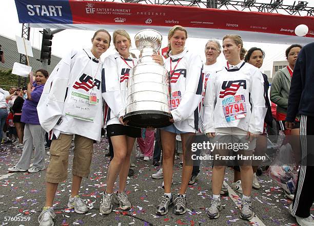 Members of the 2006 Olympic Women's Ice Hockey Team Chanda Gunn, Helen Resor, Sarah Parsons, and Jenny Potter, carry the NHL Stanley Cup at the 13th...