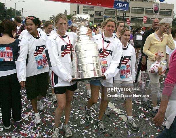 Members of the 2006 Olympic Women's Ice Hockey Team Julie Chu, Helen Resor, Sarah Parsons, and Jenny Potter, carry the NHL Stanley Cup at the 13th...