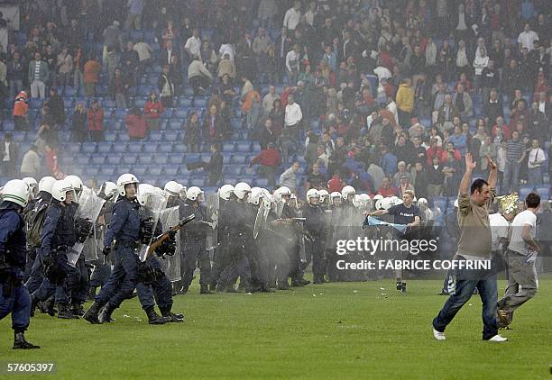 Swiss riot police push away supporters storming the field at the end of the game FC Basel versus FC Zurich during the last day of the 2005-2006 Swiss...