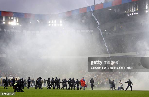 Swiss riot police take position after suppporters invaded the field at the end of a game FC Basel versus FC Zurich 13 May 2006 during the last day of...