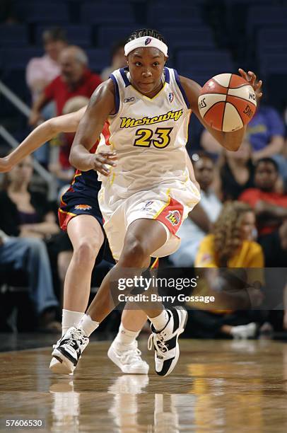 Cappie Pondexter of the Phoenix Mercury dribbles against the Connecticut Sun during their preseason WNBA game on May 13, 2006 at US Airways Center in...