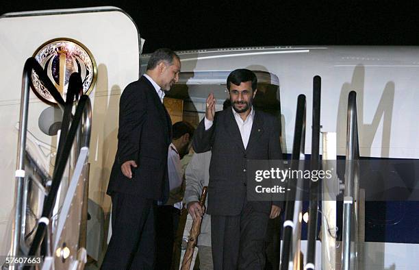 Iranian President Mahmoud Ahmadinejad is greeted by an unidentified official upon his arrival 14 May 2006 in Tehran's Mehrabad airport after a...