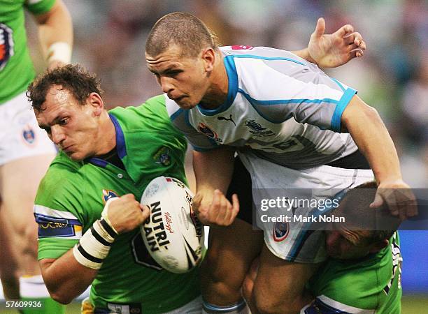 Greg Bird of the Sharks has the ball stripped by Alan Rothery of the Raiders during the round ten NRL match betweeen the Canberra Raiders and the...