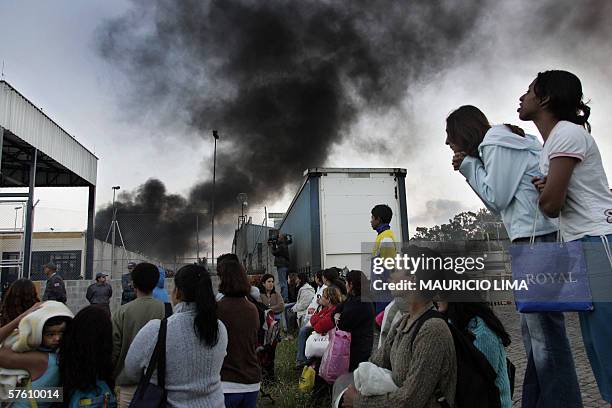 Relatives of inmates look as shock troops members enter the under-18 'Febem da Vila Maria' prison complex where a riot rose up 14 May, 2006 in Sao...